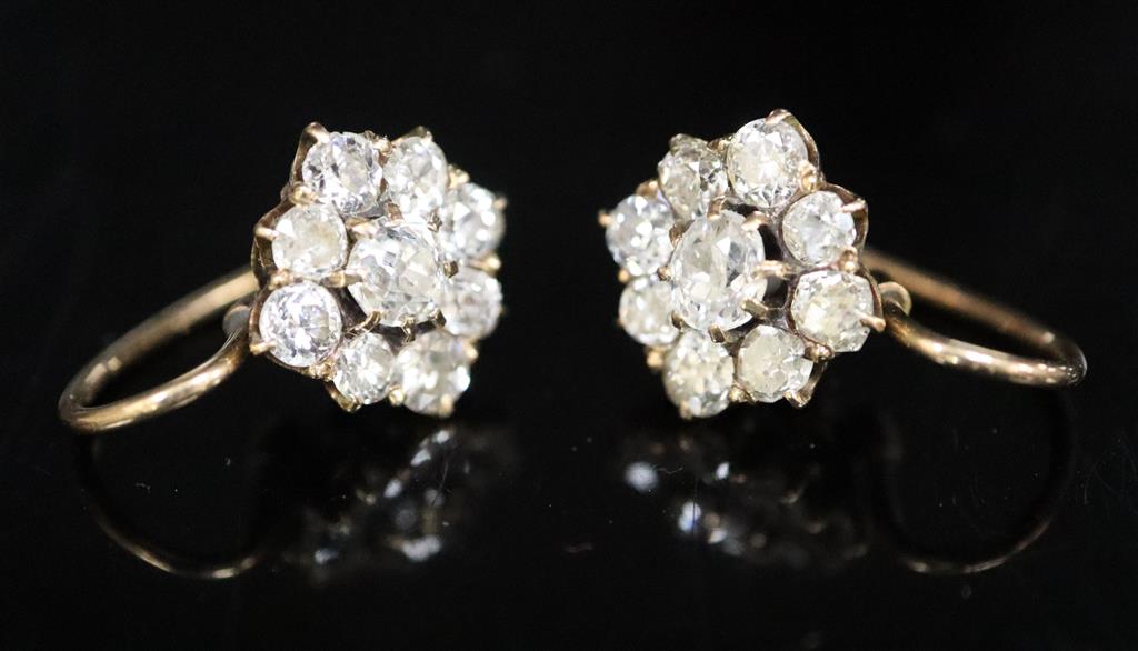 A pair of early 20th century gold and nine stone old cut diamond cluster earrings,